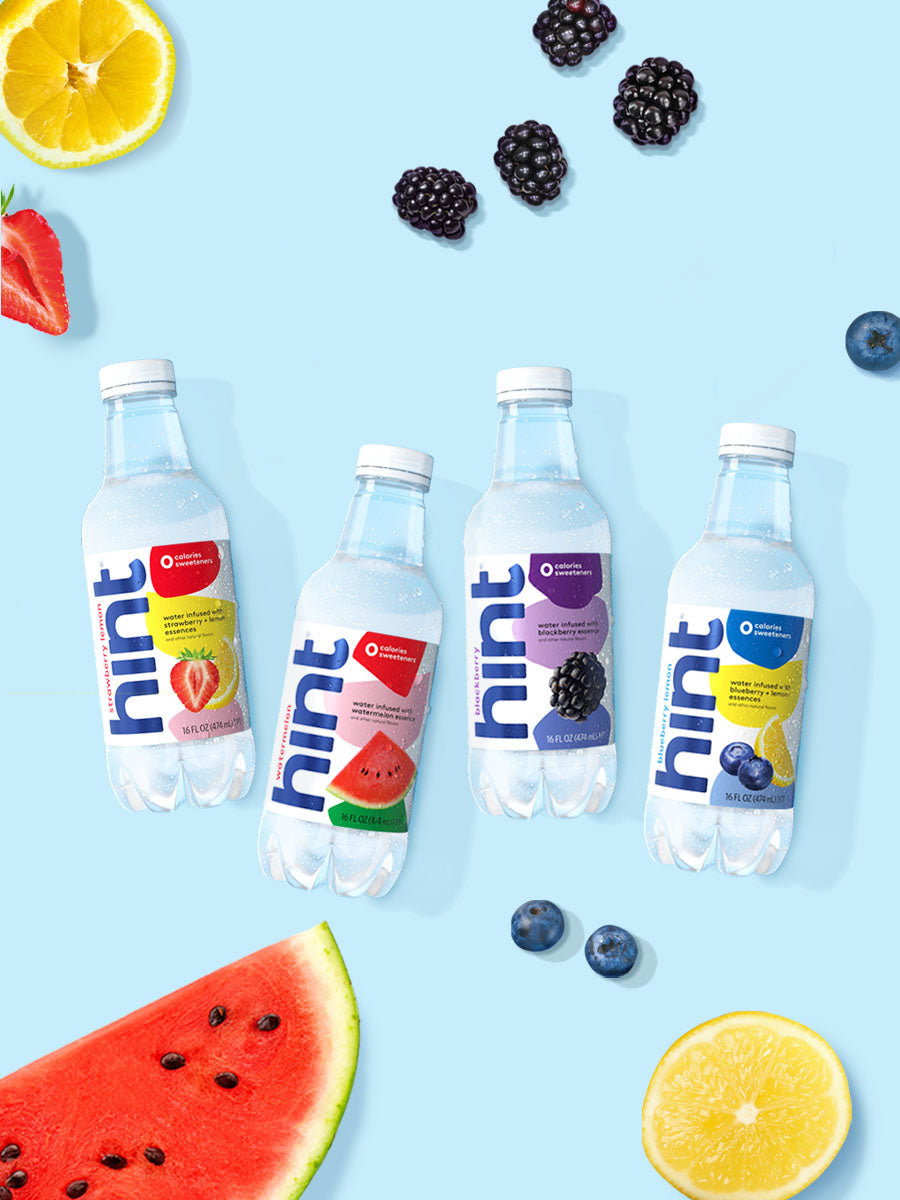 A collage of 4 hint water flavors laid on top of a light blue background with various fruits around them.