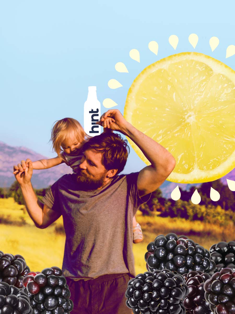 A dad holding his child over his shoulders also with a bottle of hint water.