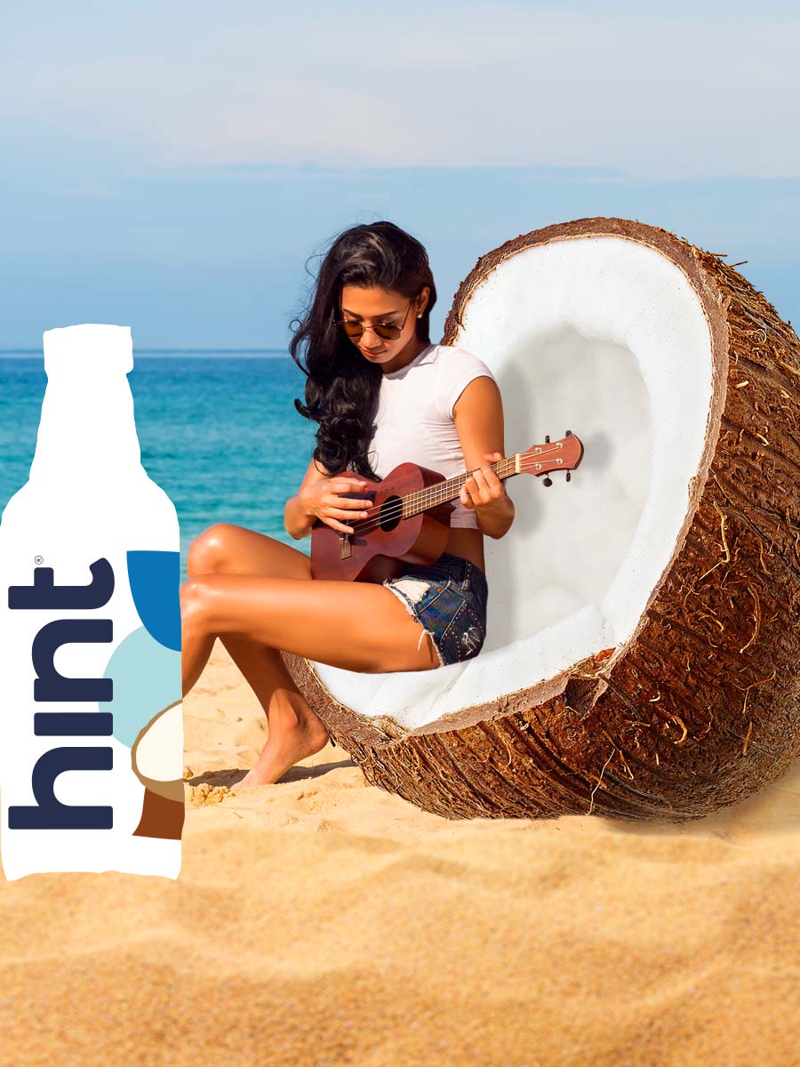 A woman sitting in an oversized coconut, like a chair, playing the ukulele at the beach. In front of her is a graphic of a hint bottle. 