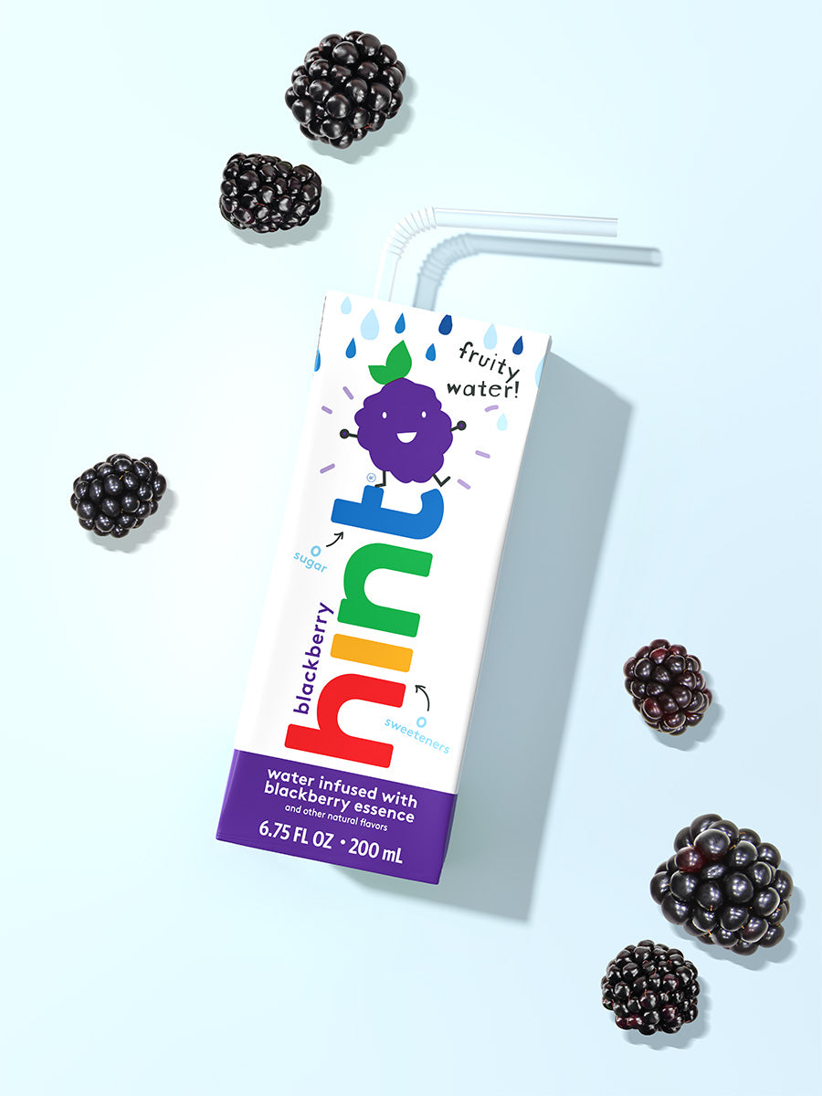 A hint kids water box on a light blue background. It is blackberry flavored so there are blackberries in the photo as well.