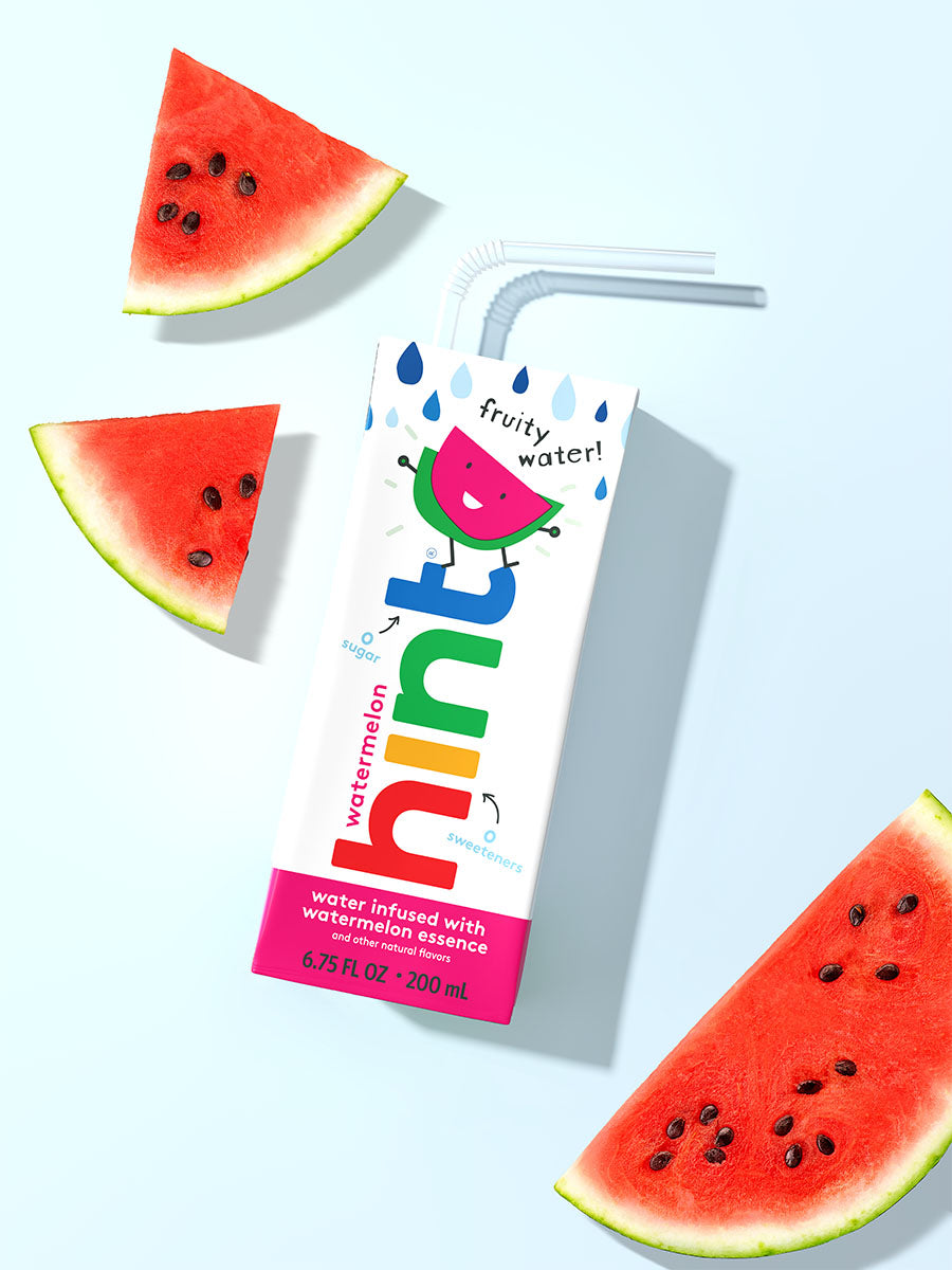 A hint kids water box on a light blue background. It is watermelon flavored so there are slices of watermelon in the photo as well.