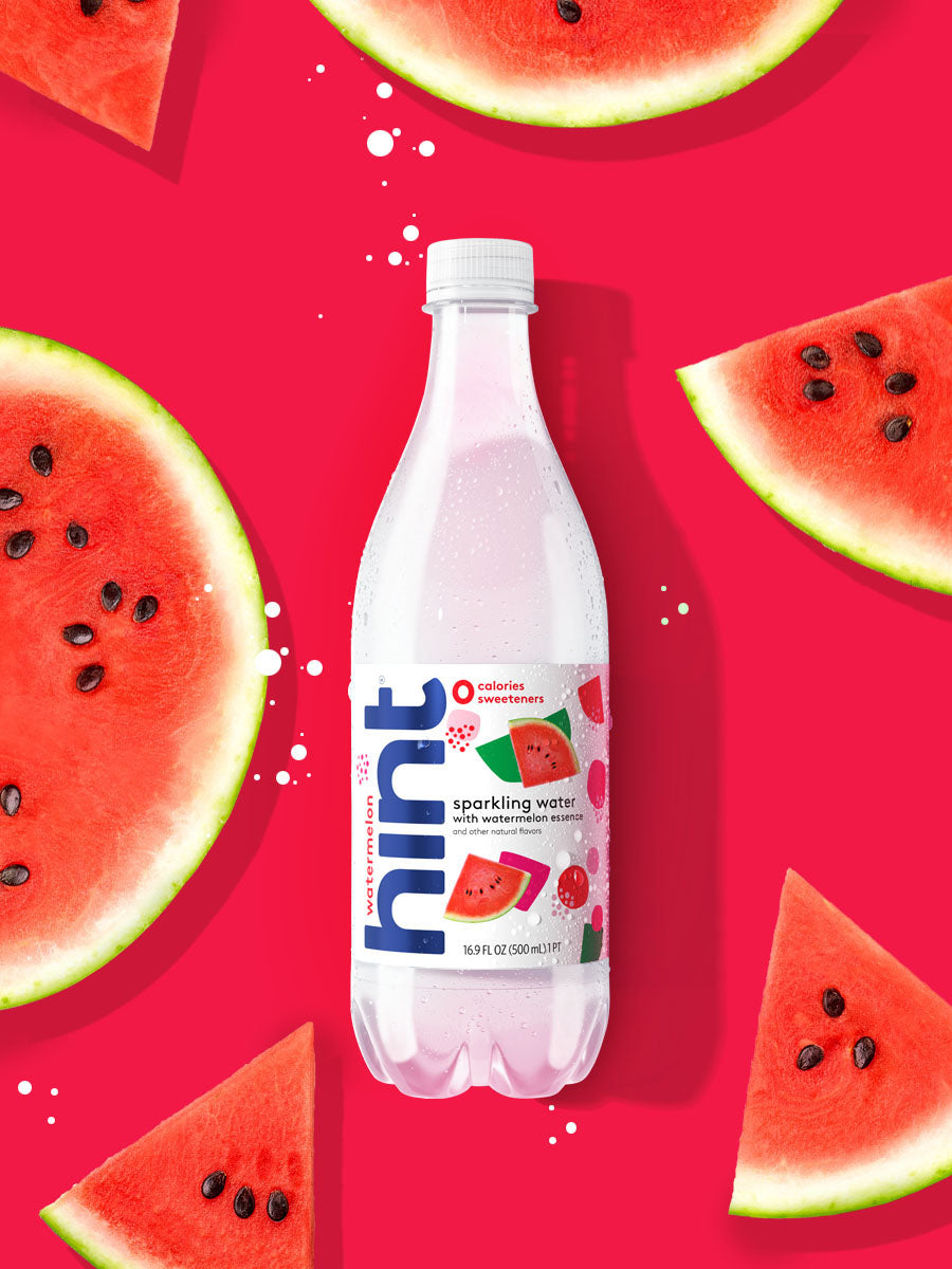 A bottle of watermelon hint sparkling water on a bright red watermelon background.